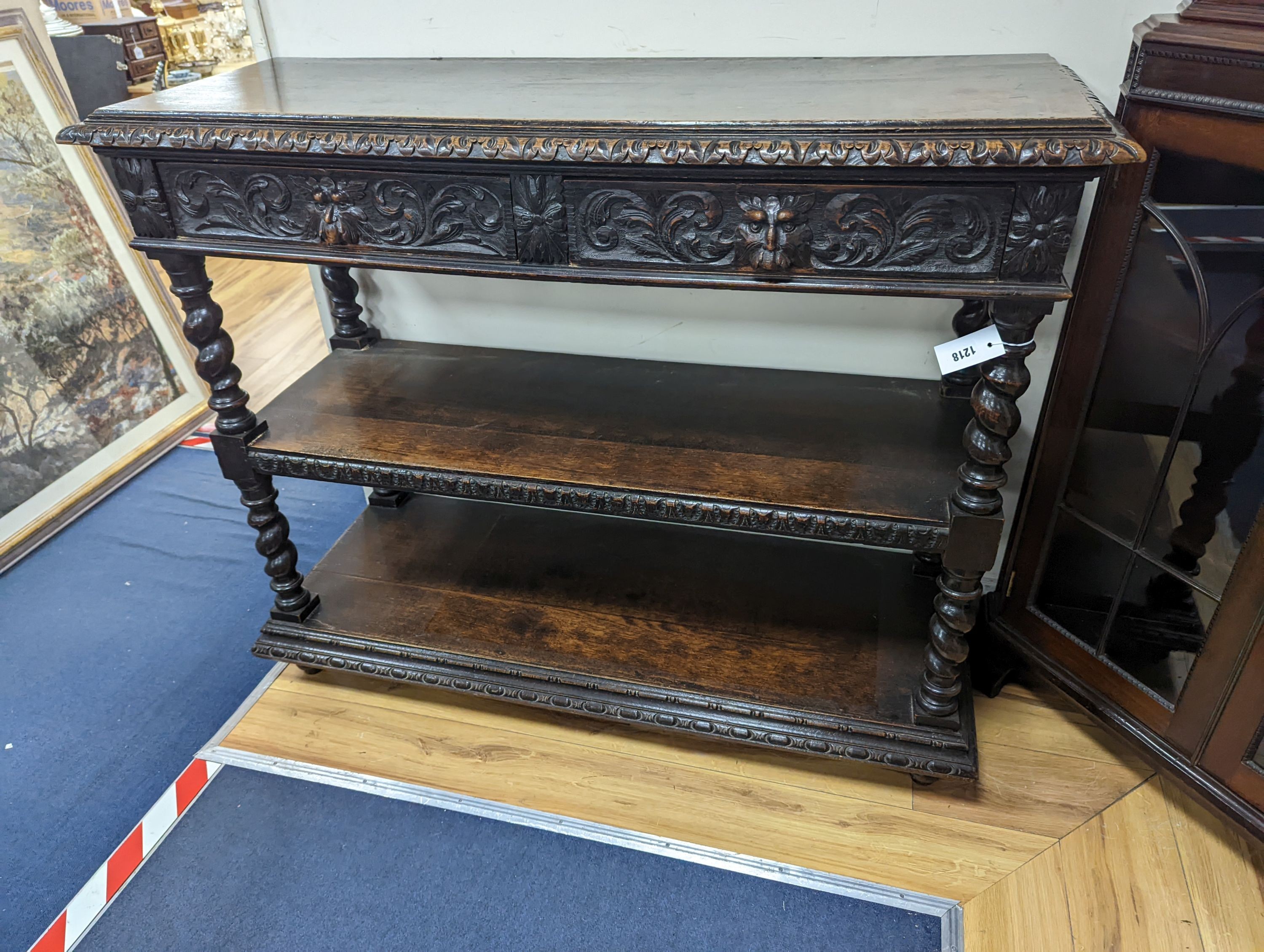 A 19th century Flemish carved oak three tier buffet, length 121cm, depth 46cm, height 98cm